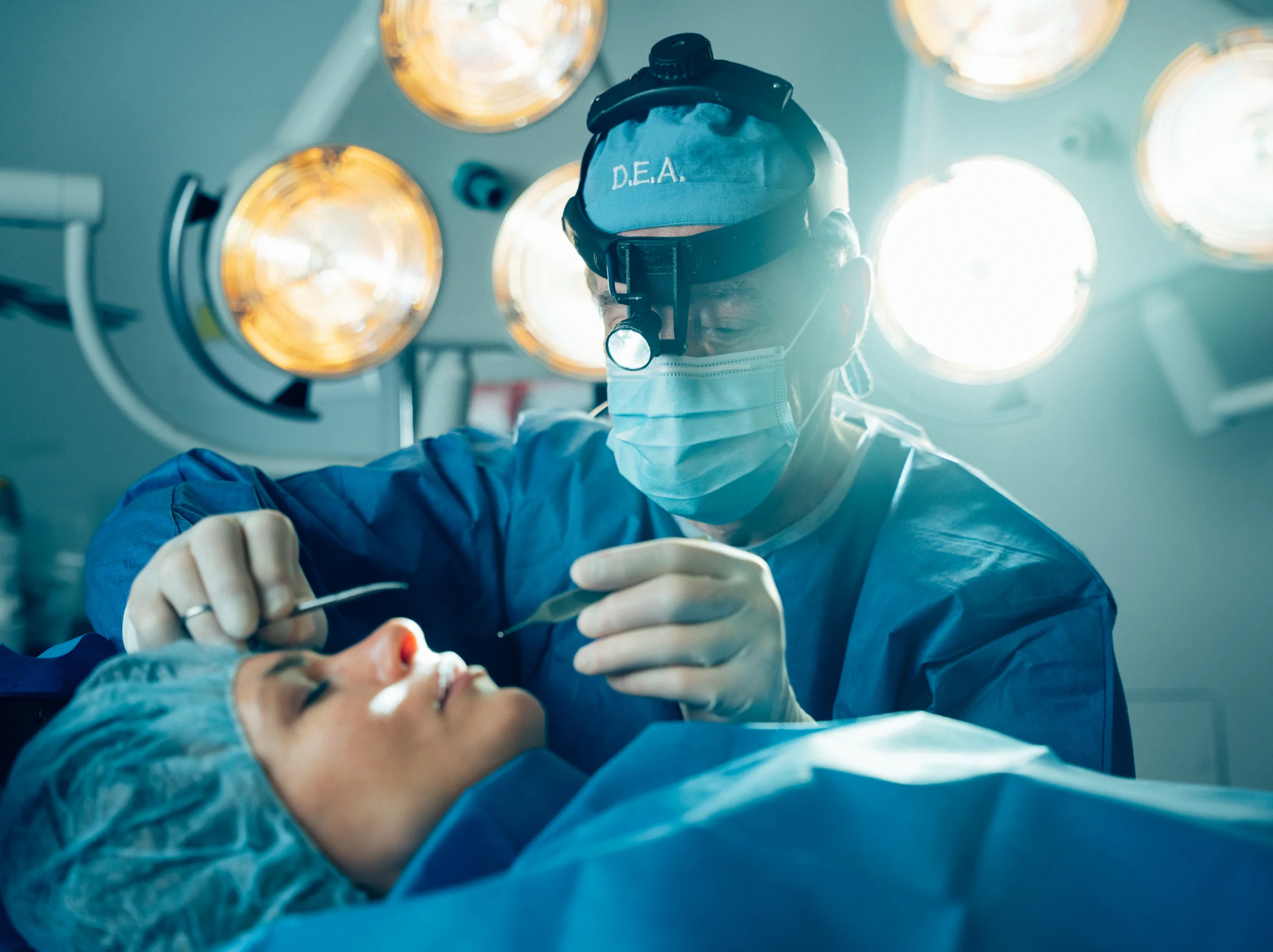 Dr Antell performing medical procedure on patient in operating room with bright surgical lights overhead - doctor in New York, NY