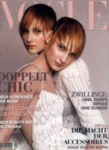 Two models in white lace on Vogue magazine cover featuring fashion and beauty editorial content