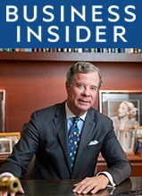 Business Insider executive in suit at desk with magazine logo above