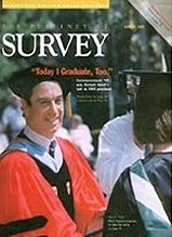 Duke Survey magazine cover featuring graduate in red academic regalia with other students in background