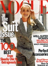 Vogue magazine cover featuring model in brown suit with red text highlighting suit issue and fashion content
