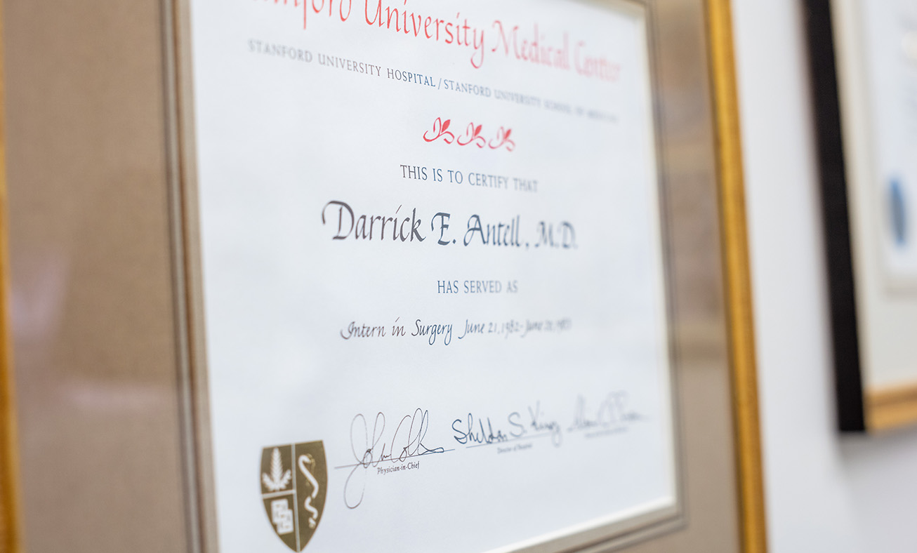 Framed medical degree certificate of Darrick E. Antell, M.D. displayed on office wall