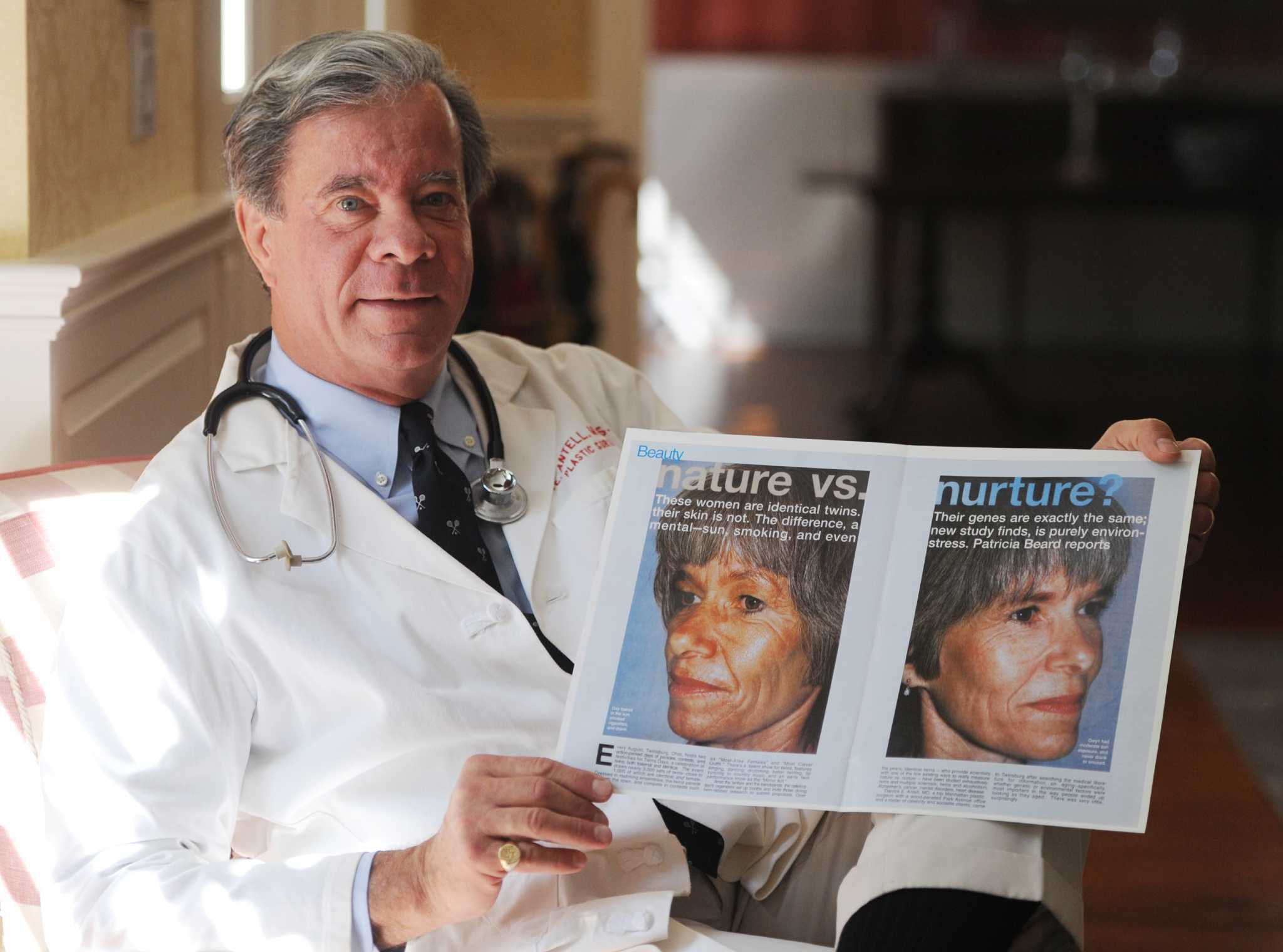 Doctor in white coat displaying before and after patient photos from facial plastic surgery procedure