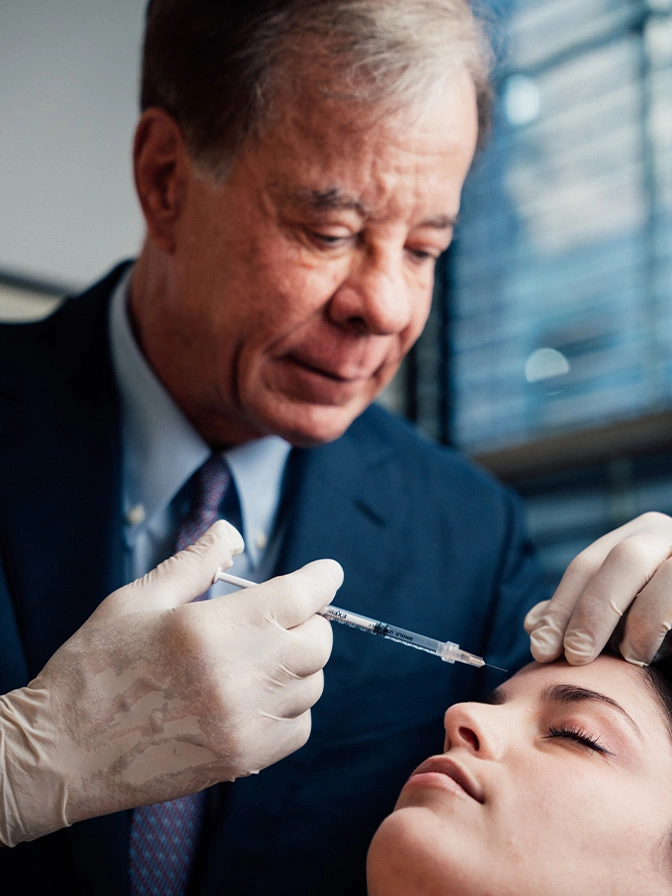 Dr Antell performing cosmetic botox injection procedure on female patient's face - botox and wrinkle relaxers in New York, NY
