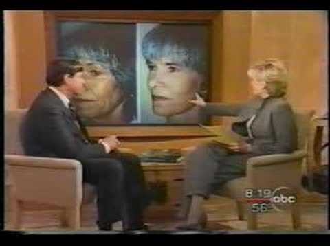 TV interview with two people in studio chairs and portrait photos displayed on screens behind them