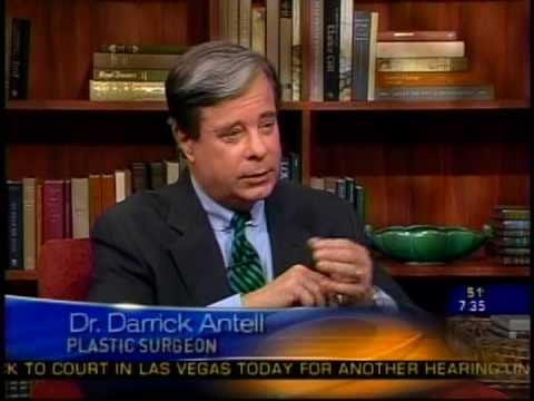 Dr. Darrick Antell being interviewed on television news program with bookshelves in background