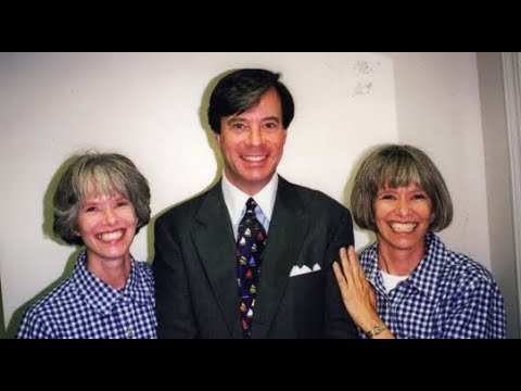 Professional business team portrait with man in suit and two women in matching checkered shirts